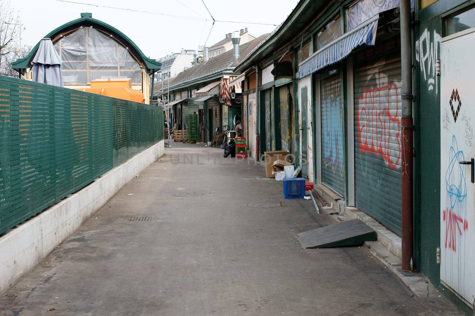 Vienna,Austria – March 31,2014: The back of the stalls with graffiti and empty pallets and boxes of the Naschmarkt on March 31,2014 in Vienna.