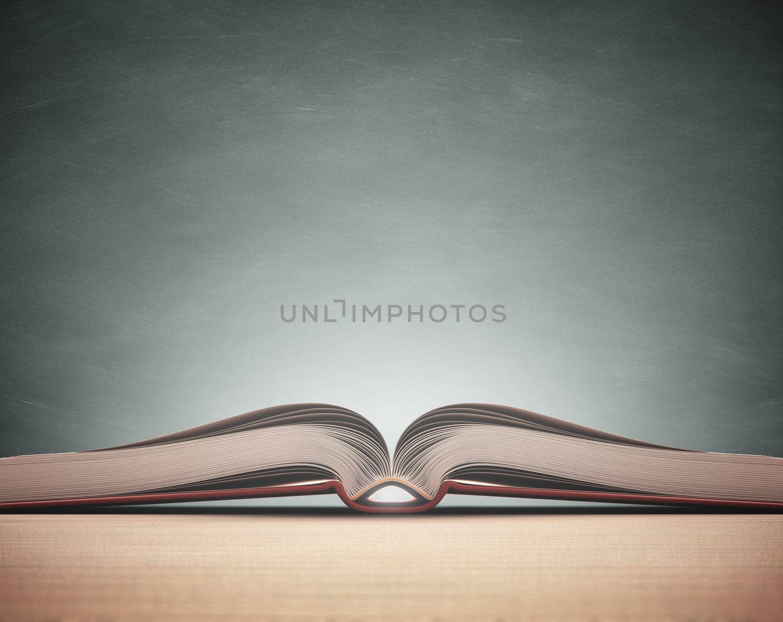 Open book over the table with blackboard on background. Clipping path included.