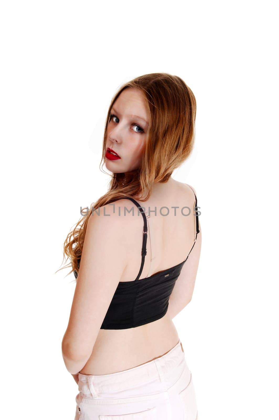 A portrait picture of a young pretty teenager girl from the back,.looking into the camera, isolated for white background..