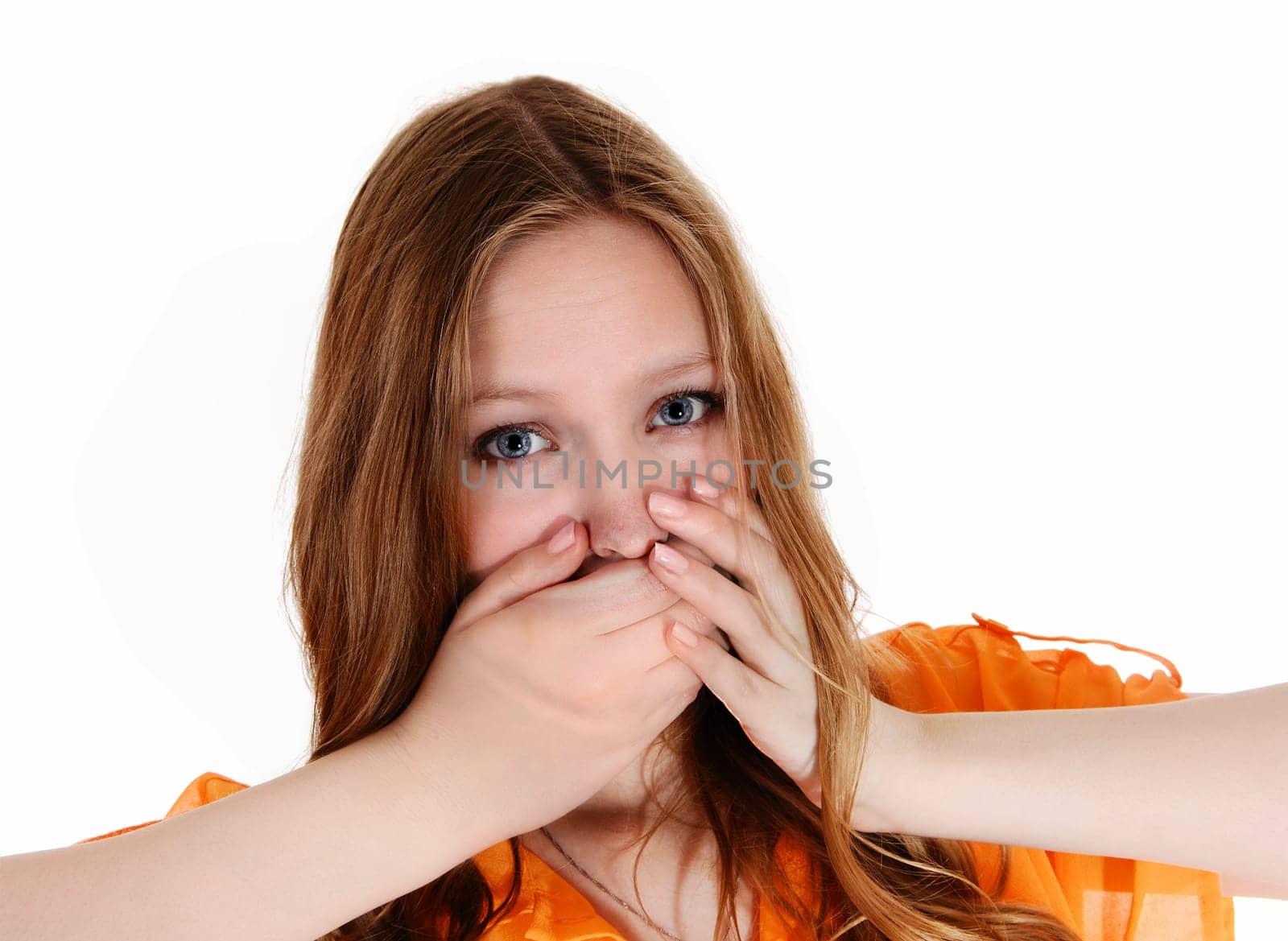 A lovely young woman holding her hands over her mouth, did say the.wrong thing, isolated for white background..