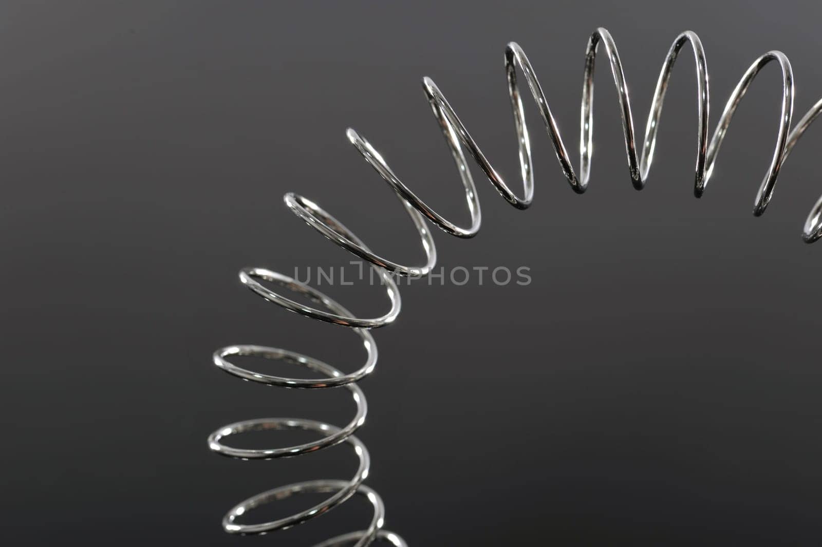 Chrome spiral bent on black background