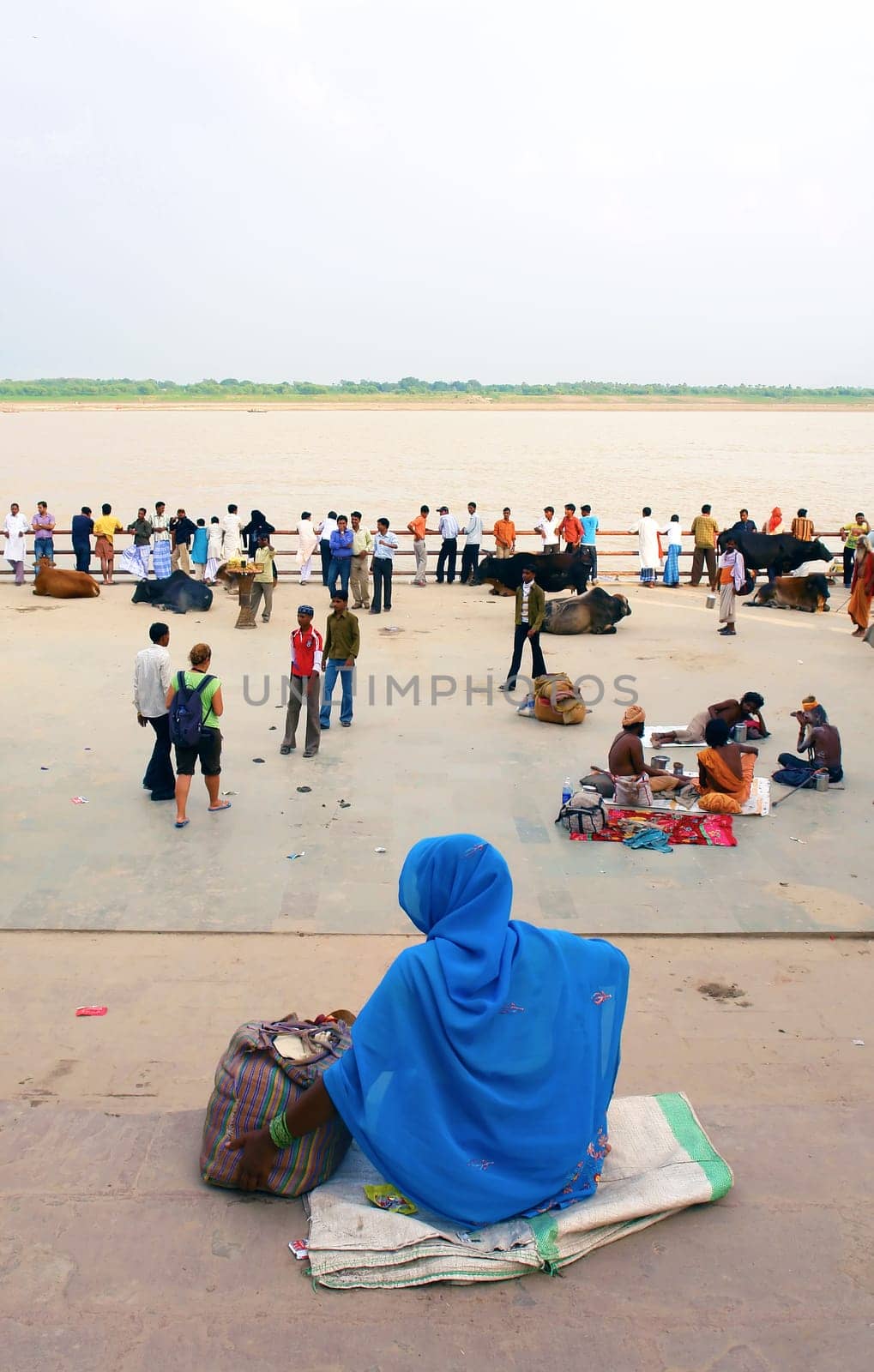 hindu men and women, in square over holy ganges in varanasi, India.