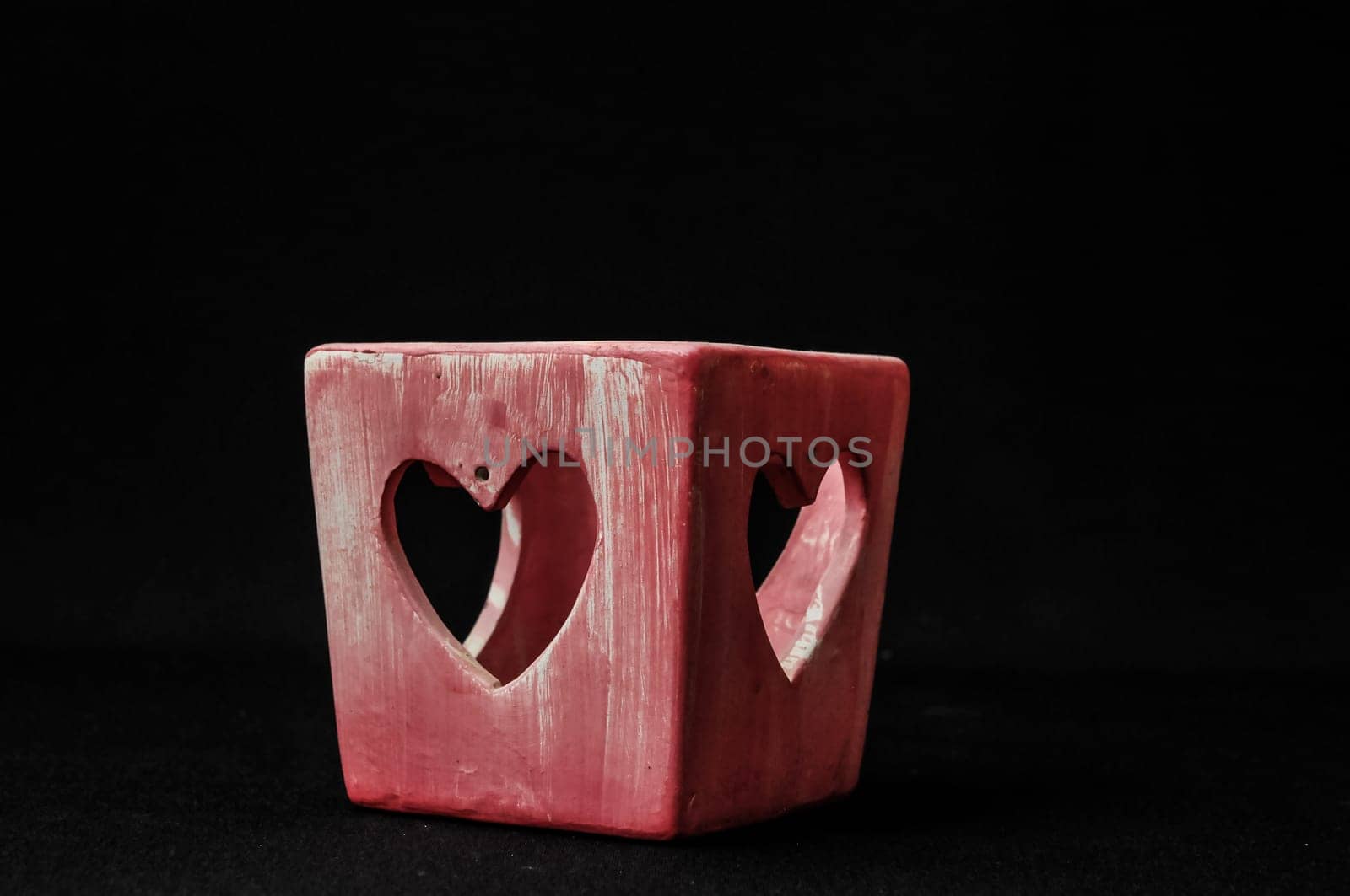 Colorful designed clay vase over a Black background