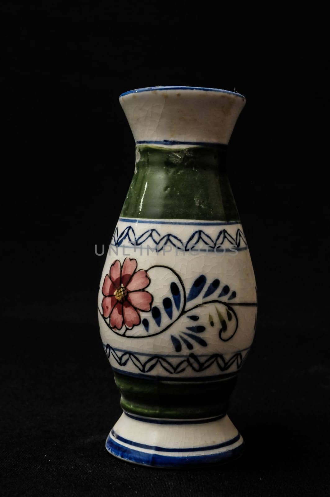 Colorful designed clay vase over a Black background