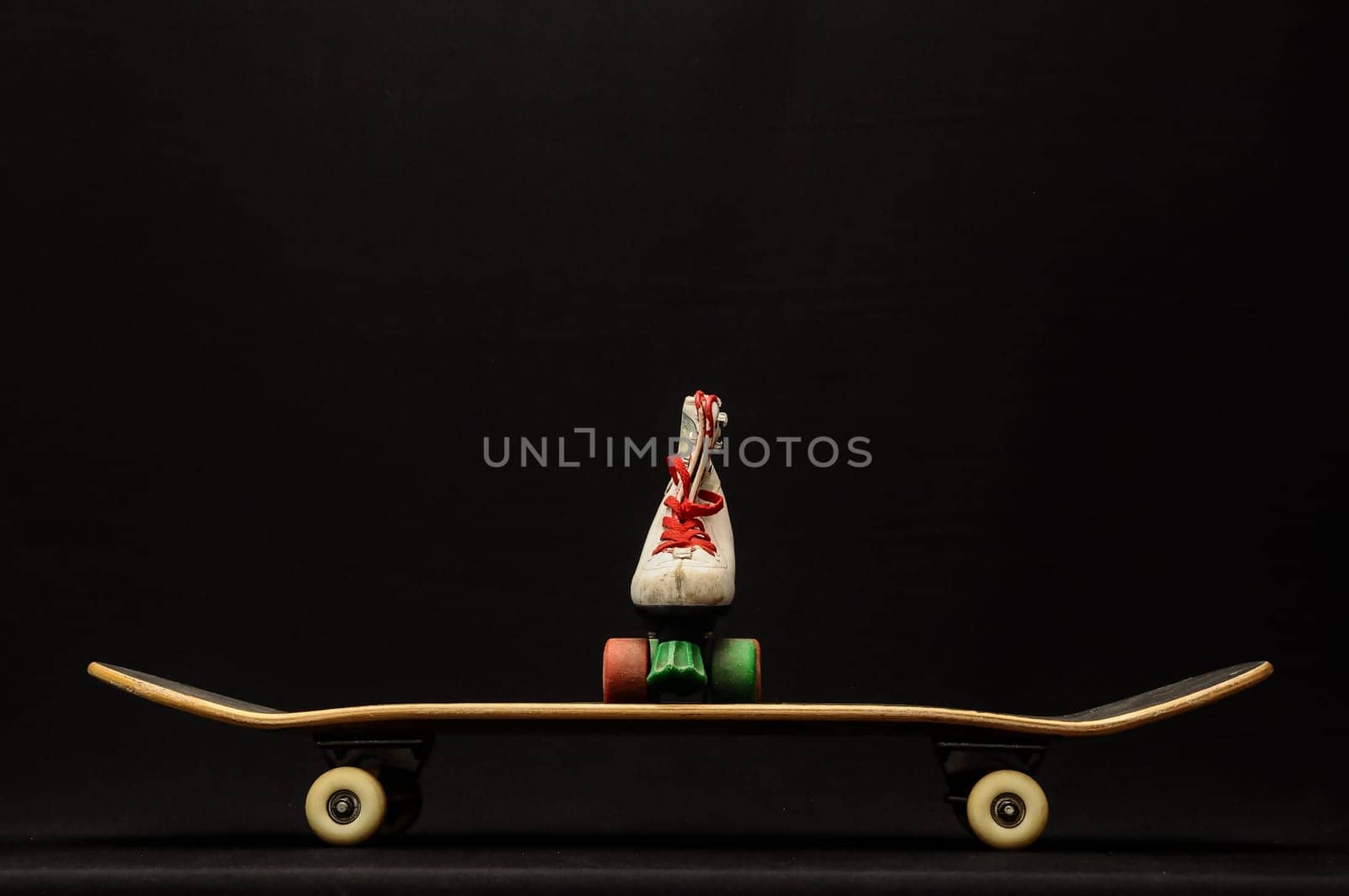 Vintage Style Black Skateboard and Skate Boot on a Dark Background