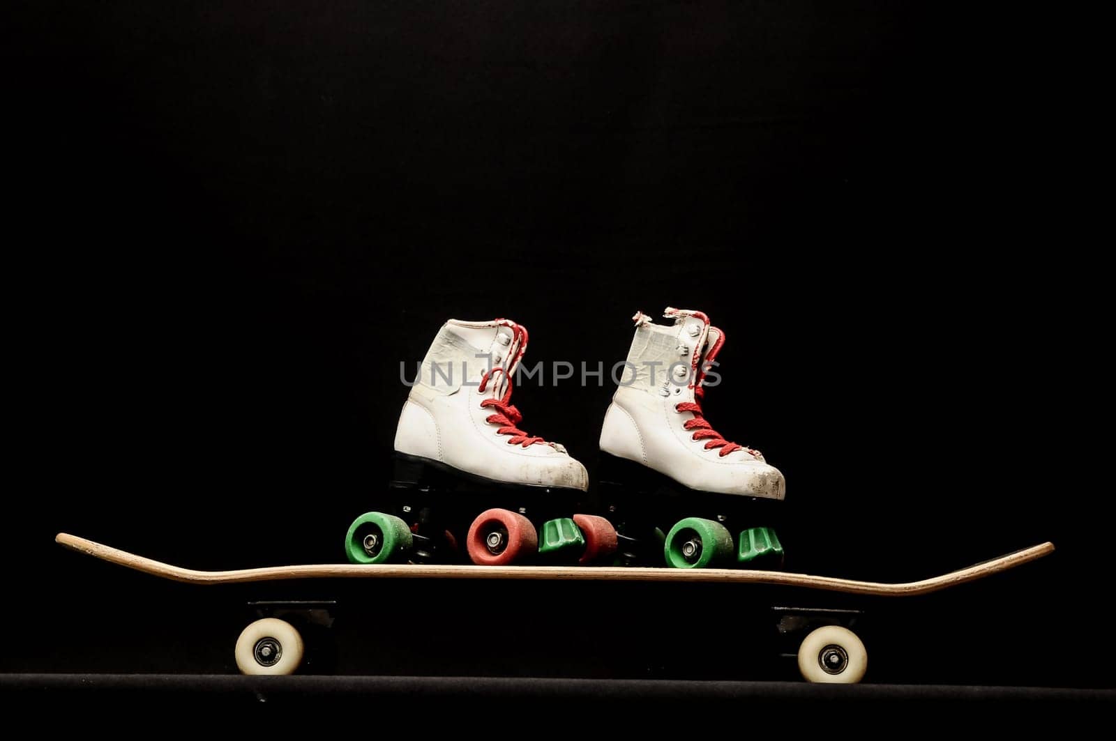 Vintage Style Black Skateboard and Skate Boot on a Dark Background
