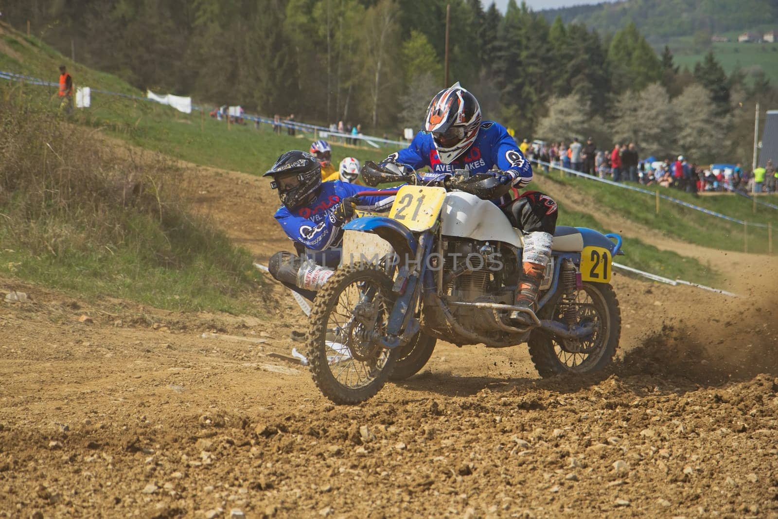 MOHELNICE, CZECH REPUBLIC - APRIL 19. Racers in blue are passing a sweep by sidecar in the "International Championship of Czech Republic 2014"" on April 19. 2014  in the town of Mohelnice, Czech Republic."