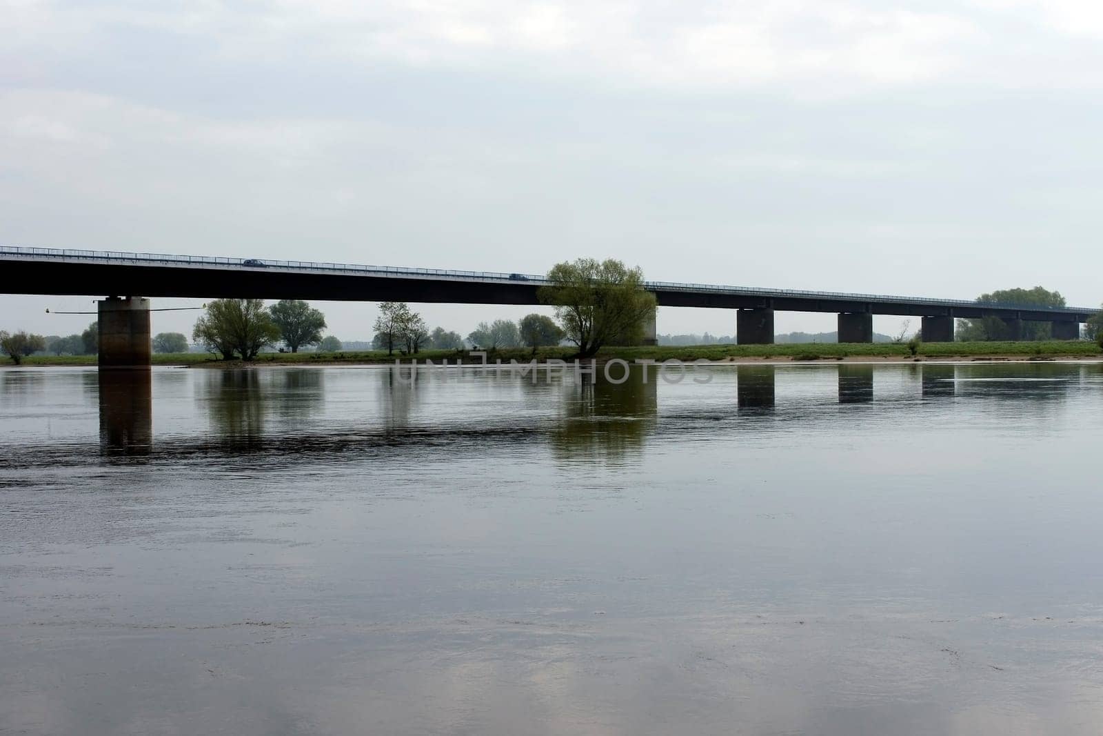 The Elbe Bridge near Wittenberge with reflections in the river Elbe and traffic.