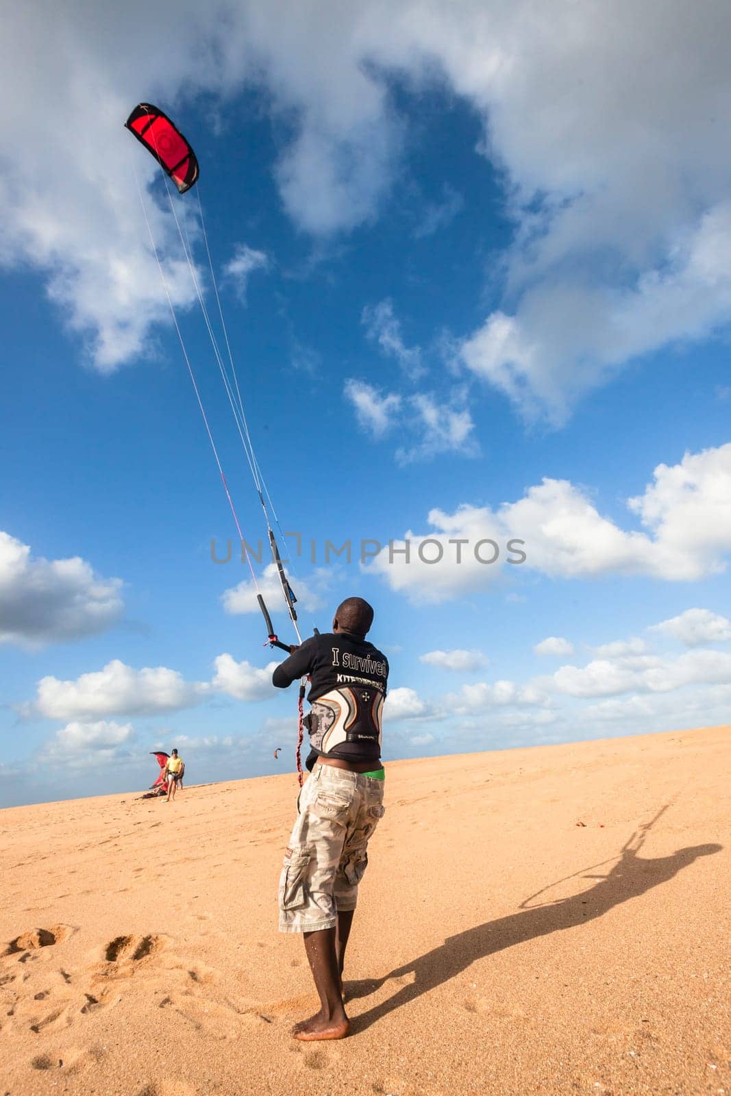 Kite surfing sport action in river lagoon waters and surf action Umdloti river lagoon north of Durban South Africa.