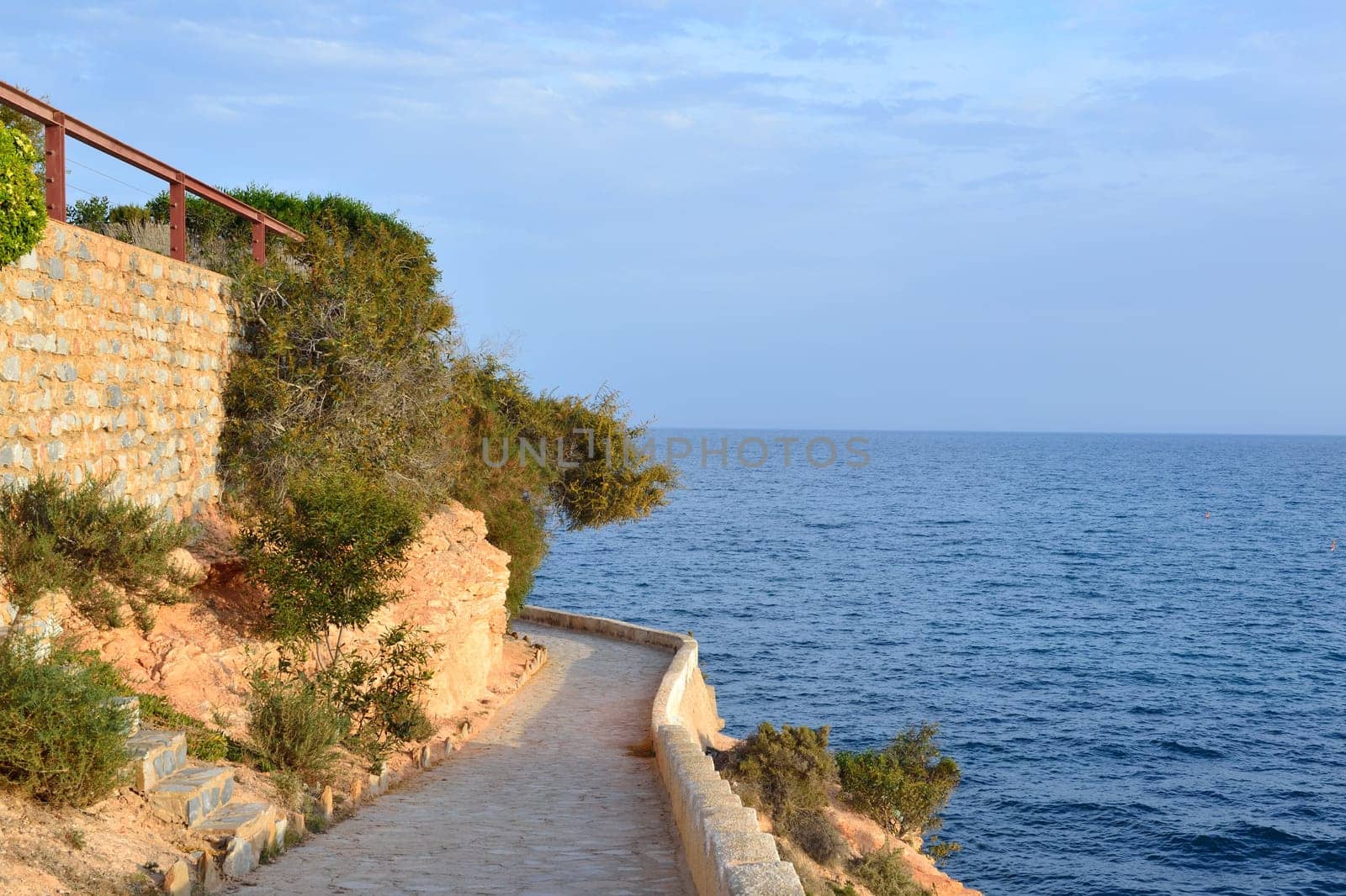 Paved coastal walkway on a summer evening, Cabo Roig, Costa Blanca, Spain