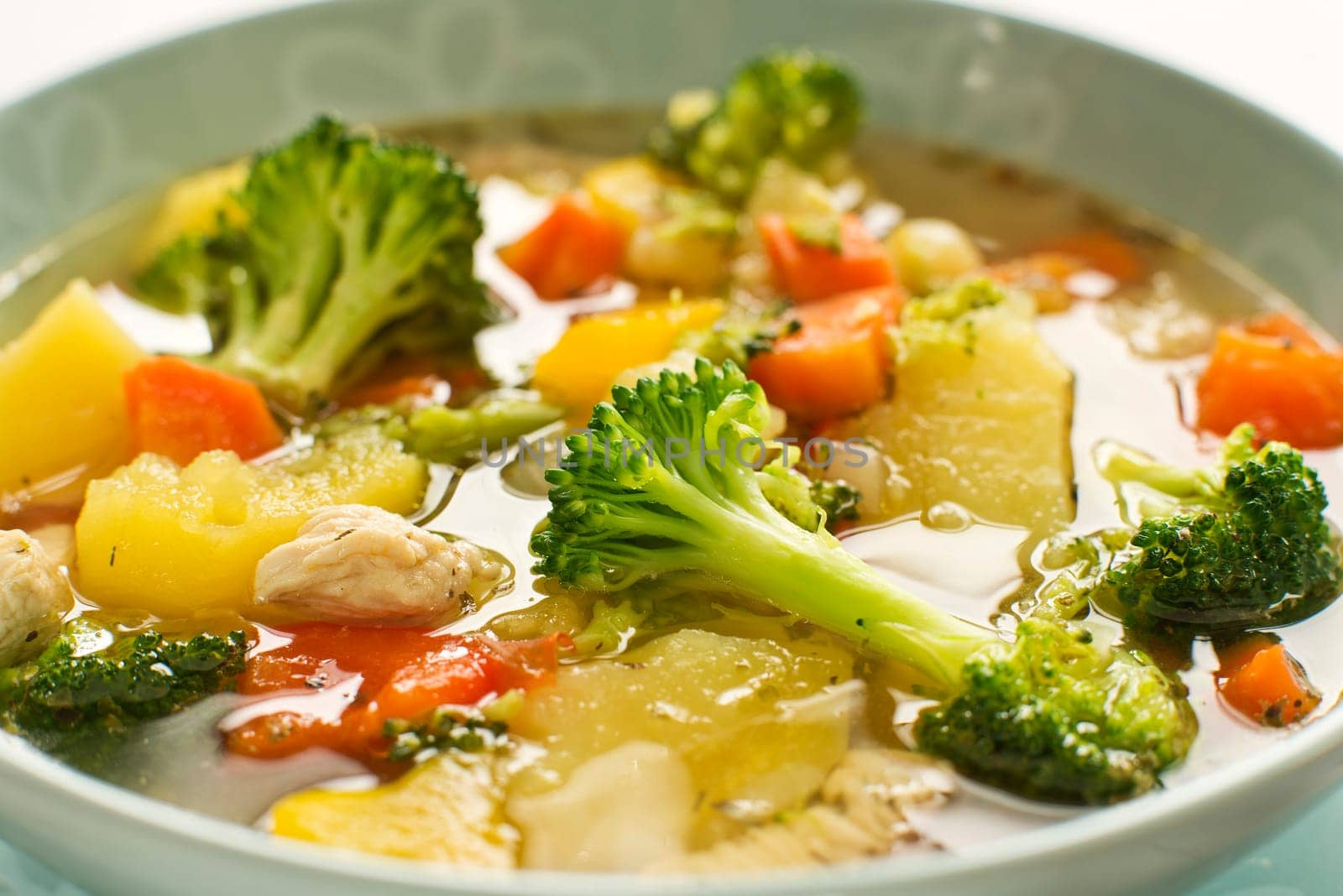 Hot chicken stew with vegetables close up