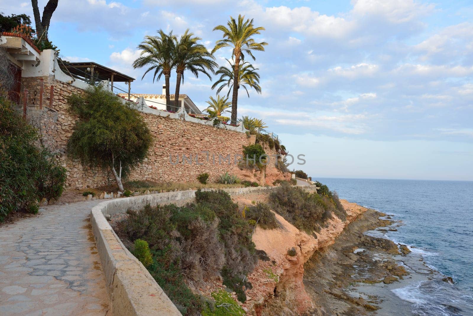 Paved coastal walkway on a summer evening, Cabo Roig, Spain