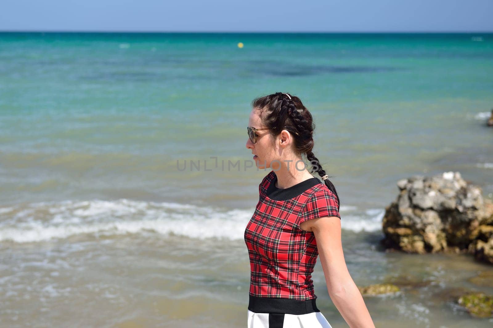 Young woman walking on the beach in a nice summer day, Costa Blanca, Spain