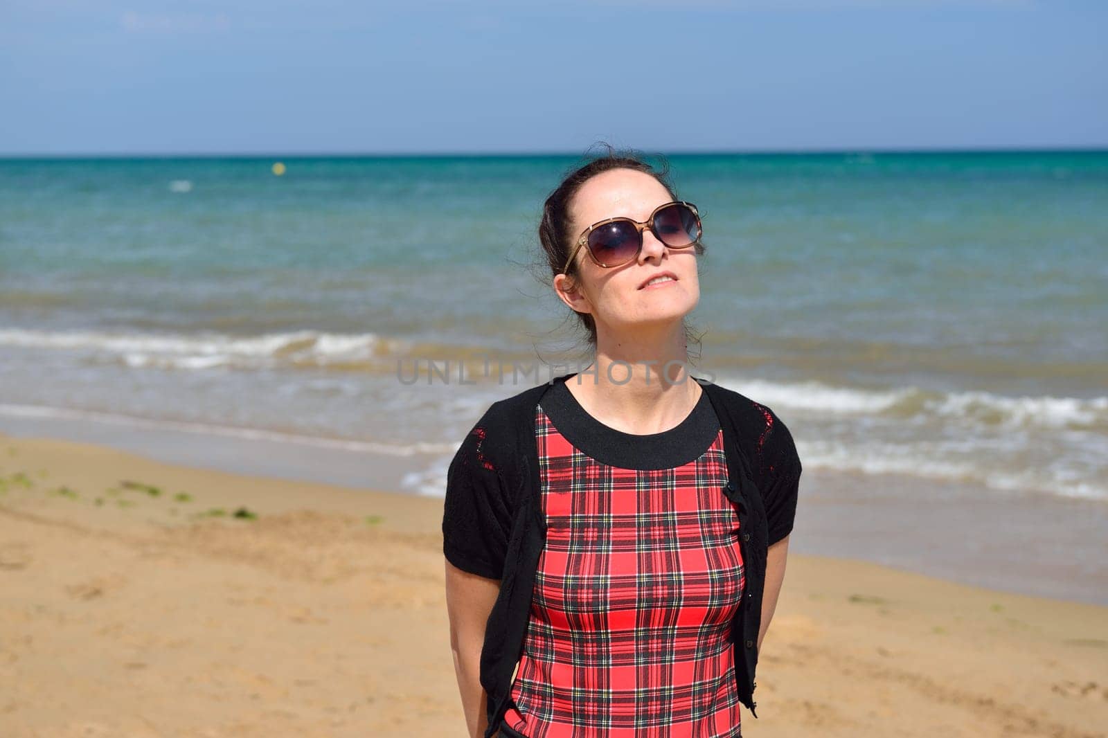 Young woman walking on the beach in the sand in a nice summer day, Costa Blanca, Spain