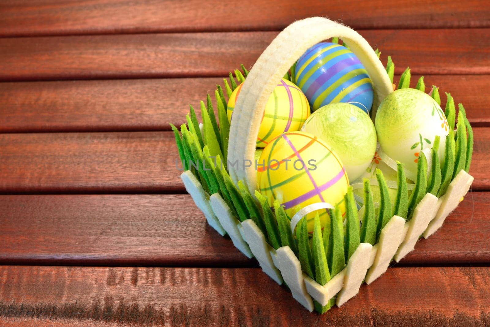 Eastern eggs and basket on a wood table