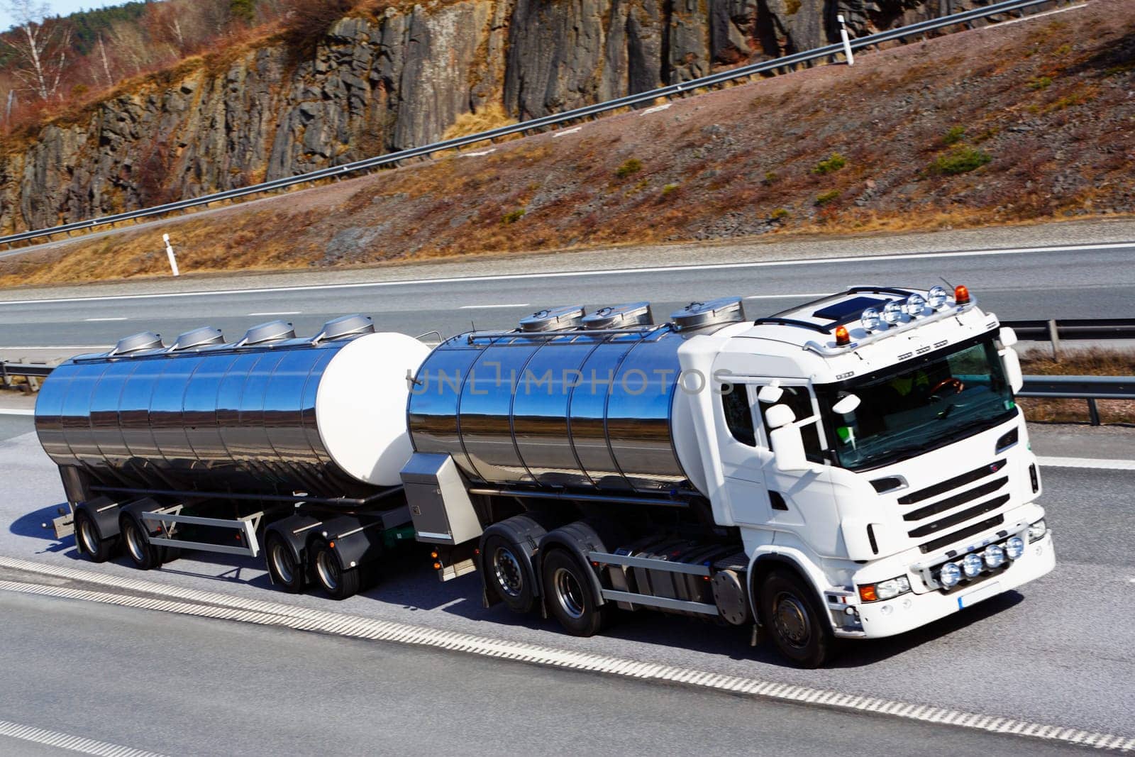 large clean fuel-truck in motion, focal-point on the side of truck.