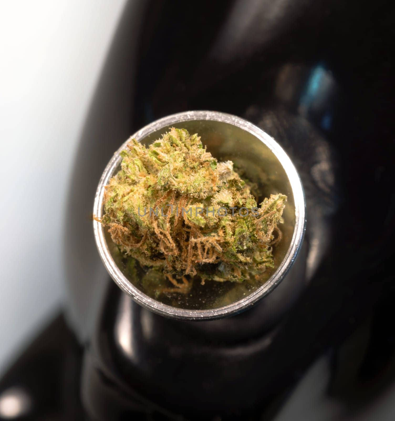 Broken Green Buds sitting in the bowl before a smoke