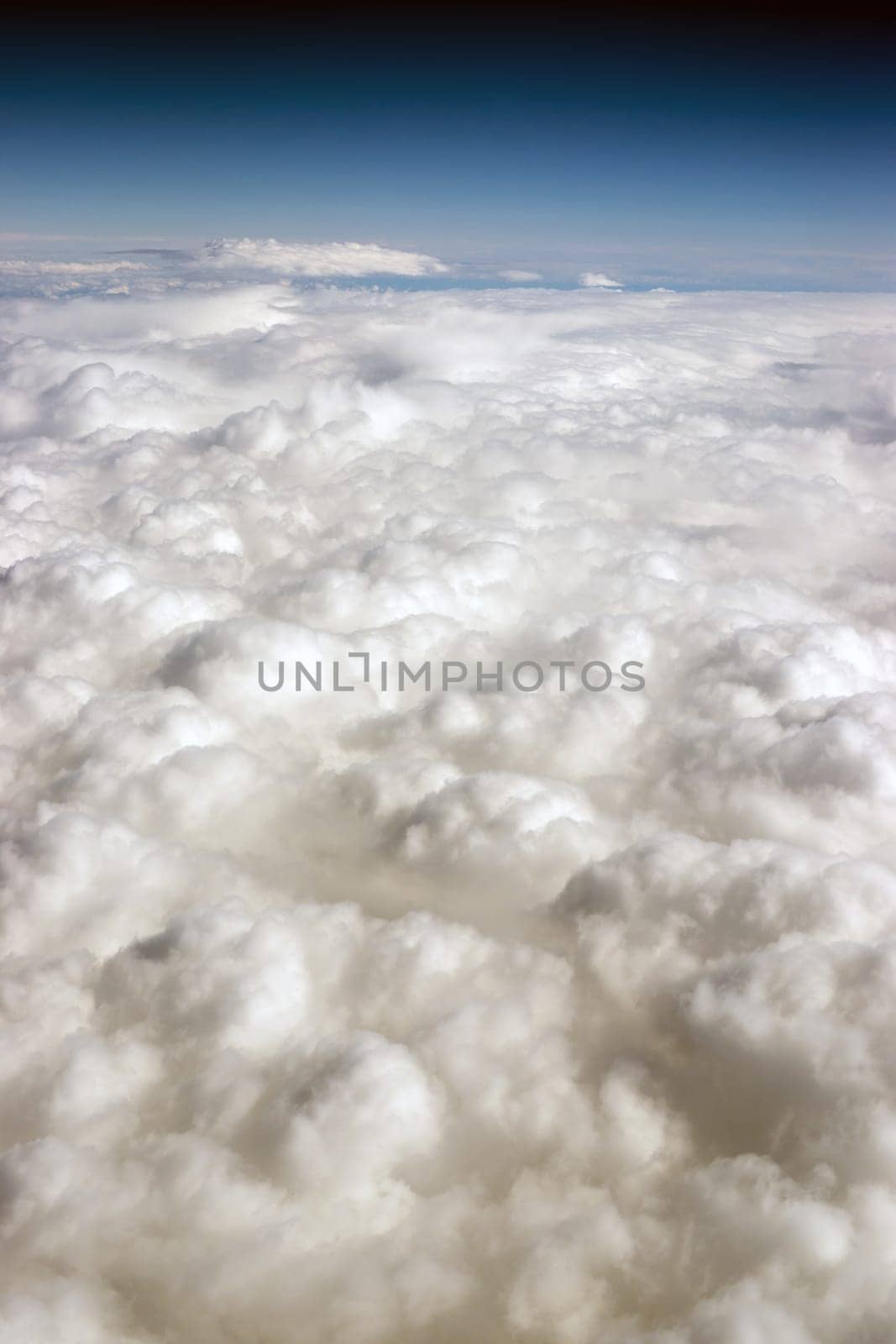 Vertical composition blue sky and fluffy high clouds