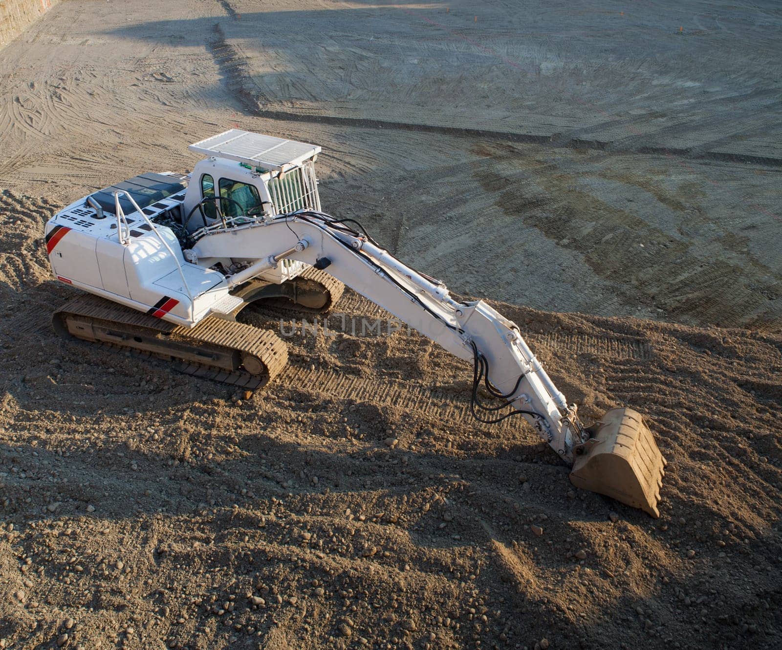 View of white excavator on the construction site