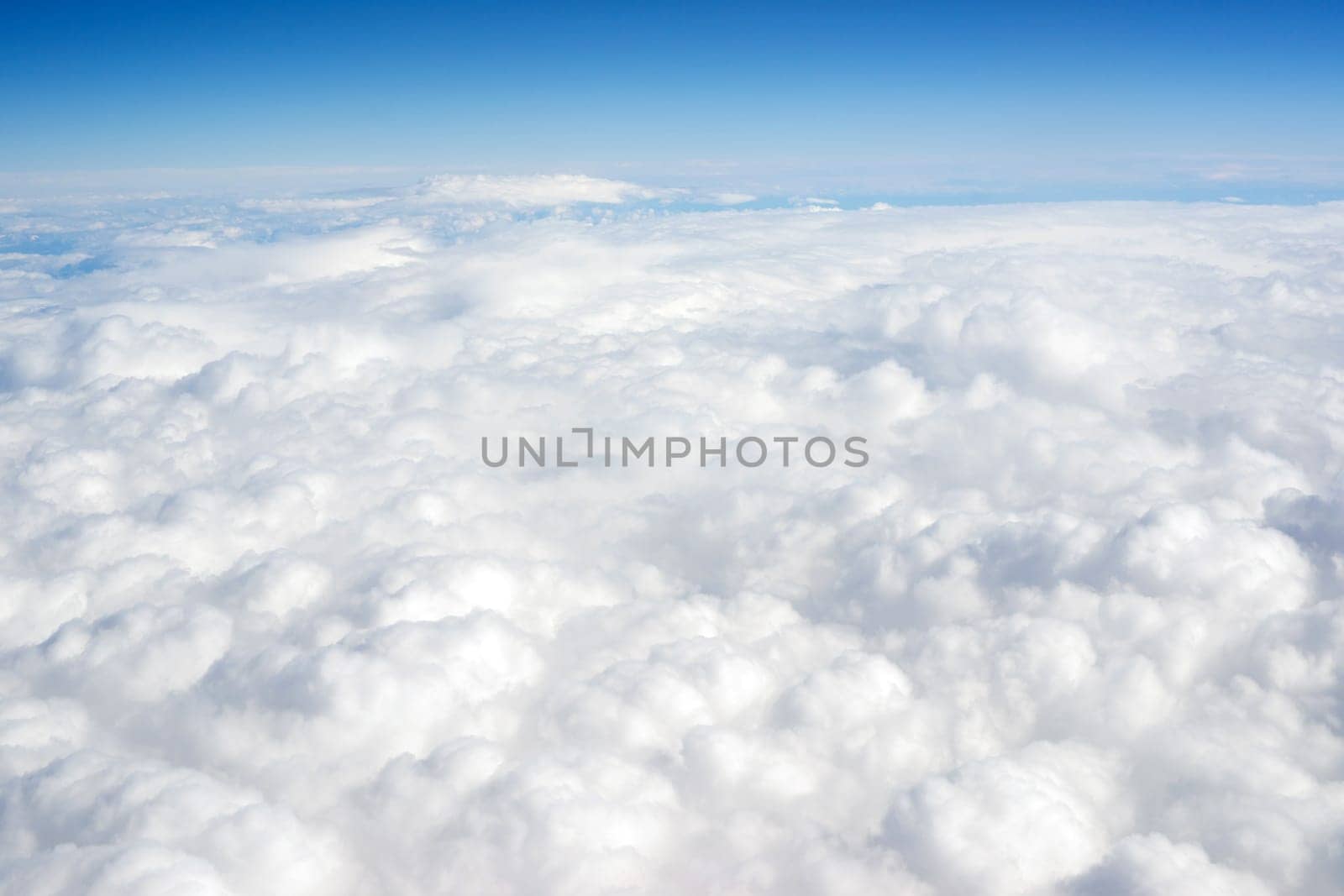 Vertical composition blue sky and fluffy high clouds
