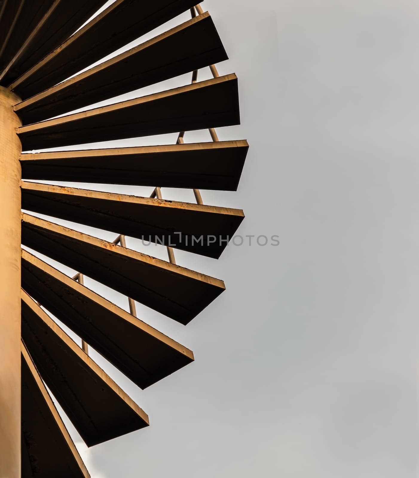 Brown metal spiral staircase pattern with iron railing for Decoration exterior on sky background. Spiral wrought steel staircase circular staircase with Copy space for design, Selective focus.