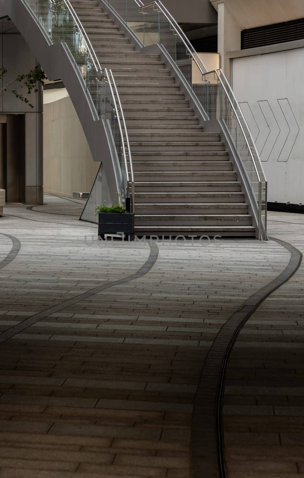 London, UK - Oct 13, 2023 - View of an external modern staircase with stainless steel railing handle grip and glass. Interesting architectural elements, Copy space, Selective focus.