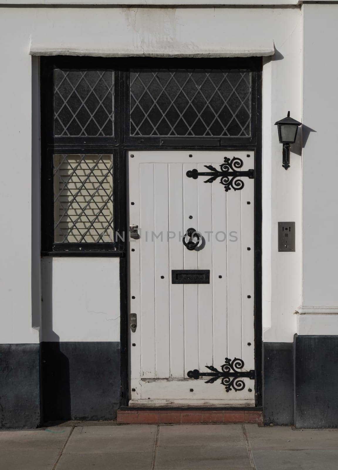 London, UK - Oct 24, 2023 - Front door of a house in De Vere Cottages and street light at South Kensington. Space for text, Selective focus.