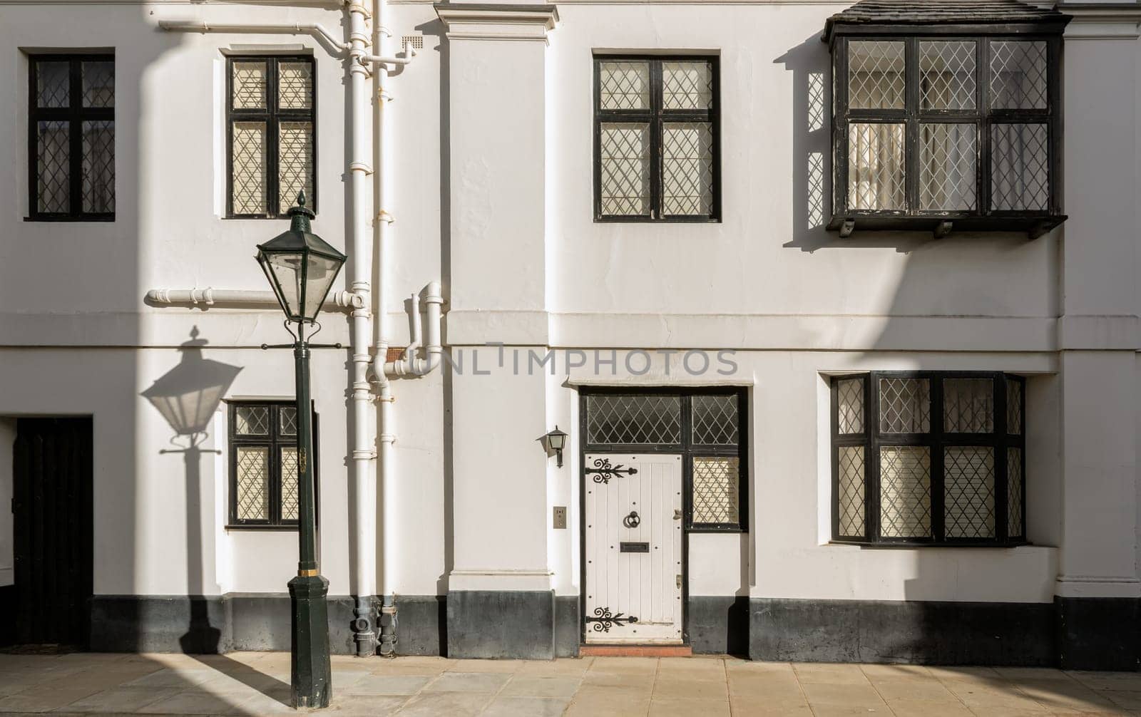 London, UK - Oct 24, 2023 - Facade of a house in De Vere Cottages and street light at South Kensington. Space for text, Selective focus.