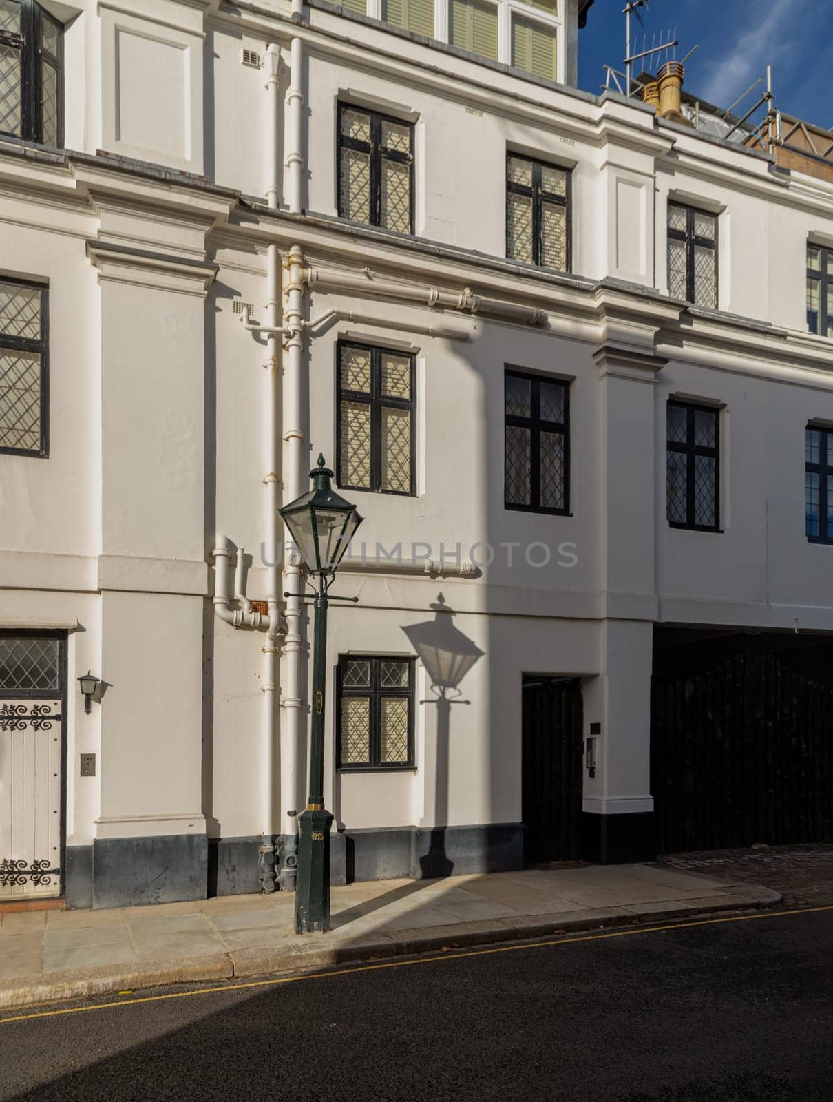 London, UK - Oct 24, 2023 - The shadow of the Street light in front of House in De Vere Cottages at South Kensington. Space for text, Selective focus.