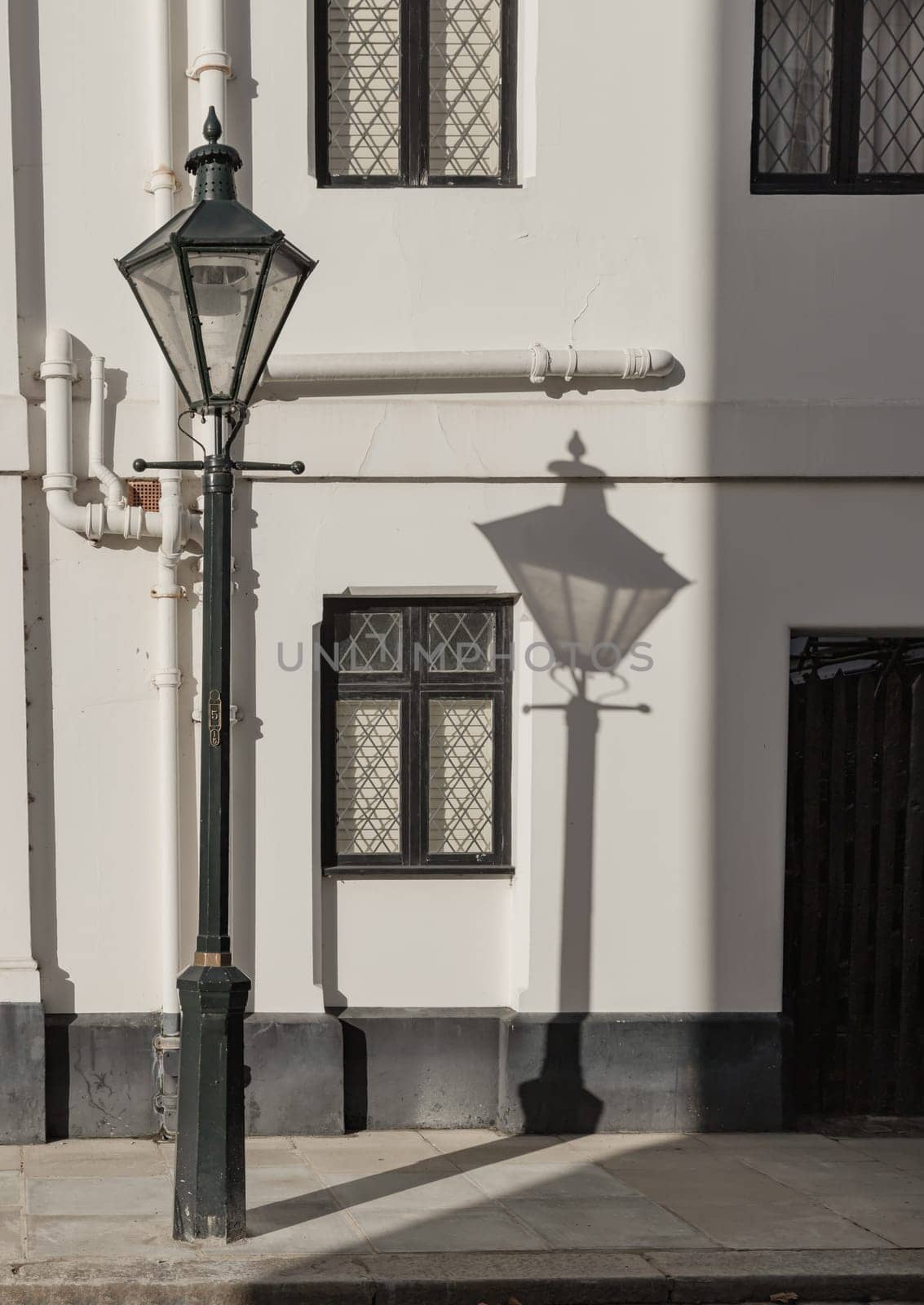 London, UK - Oct 24, 2023 - The shadow of the Street light in front of House in De Vere Cottages at South Kensington. Space for text, Selective focus.