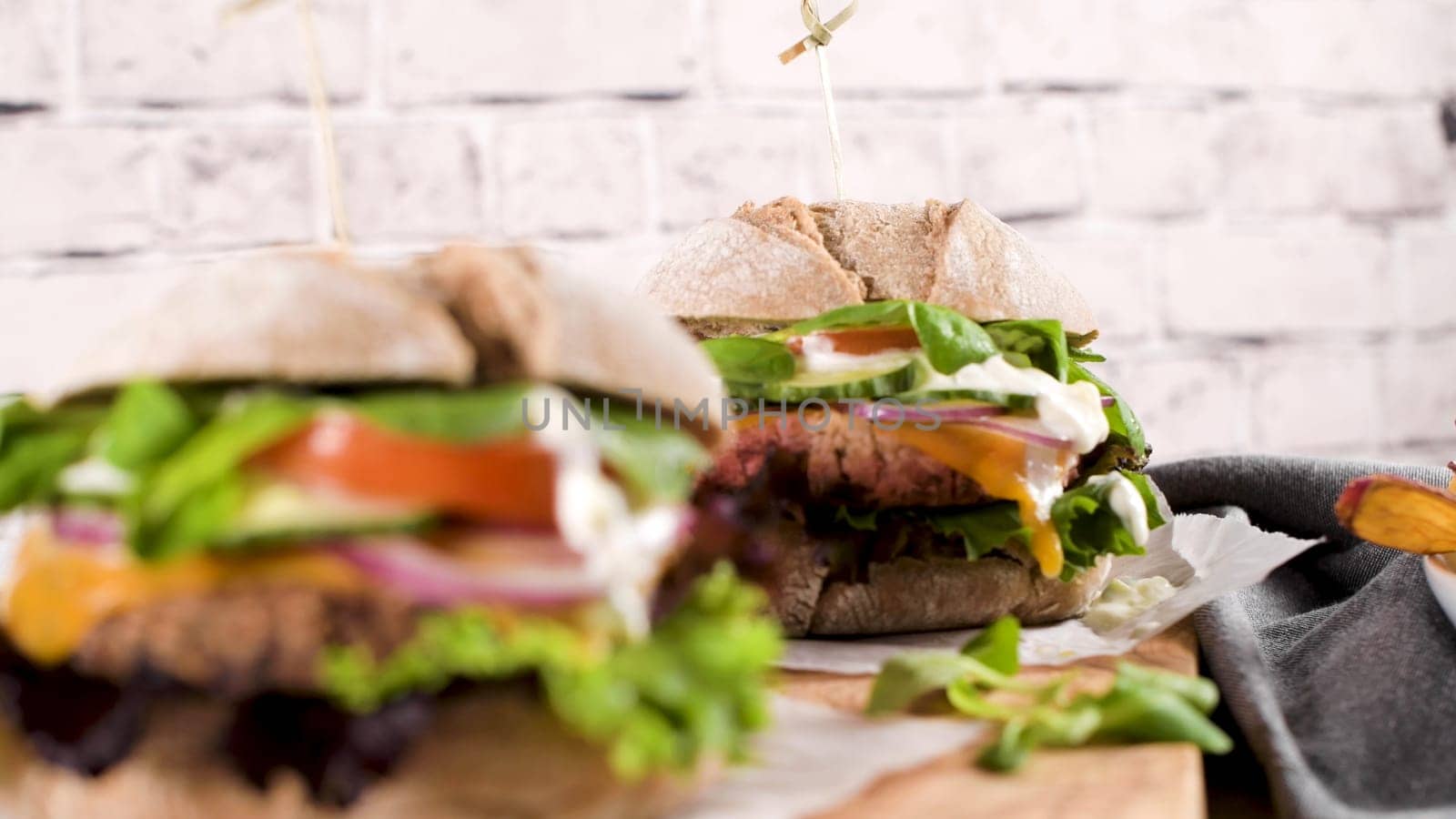 Healthy vegan burger with fresh vegetables and yogurt sauce by homydesign