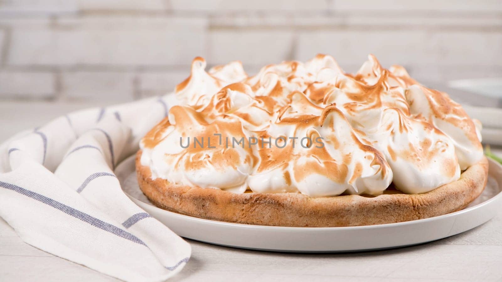 French tart with  Merengue on white wooden background. Pastry tasty homemade tart and pie with napkin.
