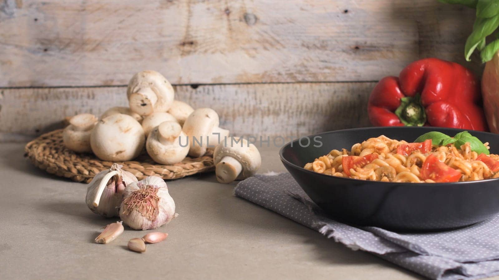 Italian Pasta with Tuna and Basil. Fresh pasta with tuna and tomato sauce on old wooden background.