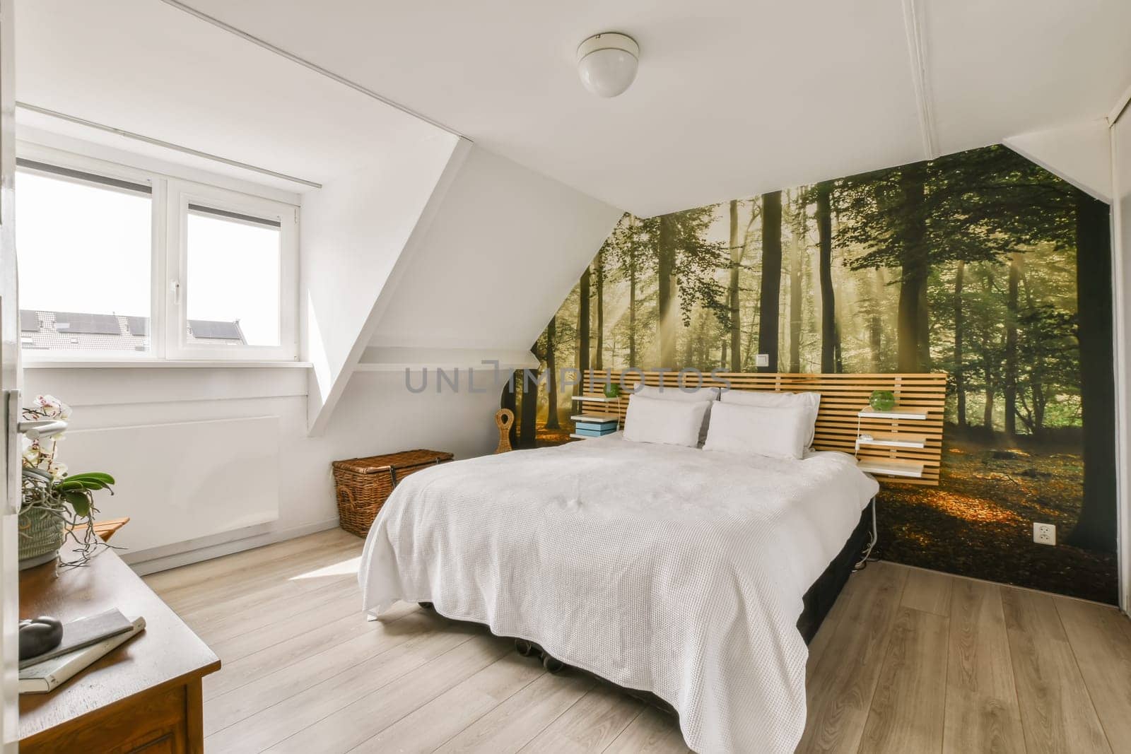 a forest is on the wall next to the bed in this modern bedroom with white walls and hardwood flooring