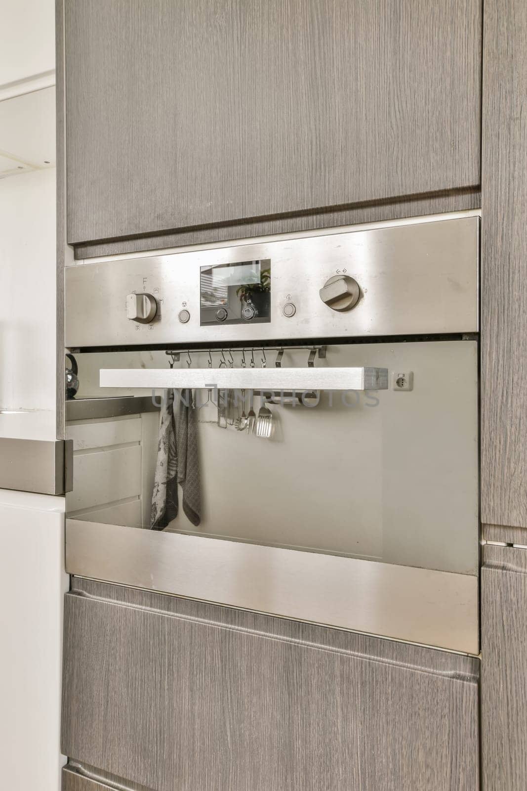 the stainless steel oven in the kitchen of a home by casamedia