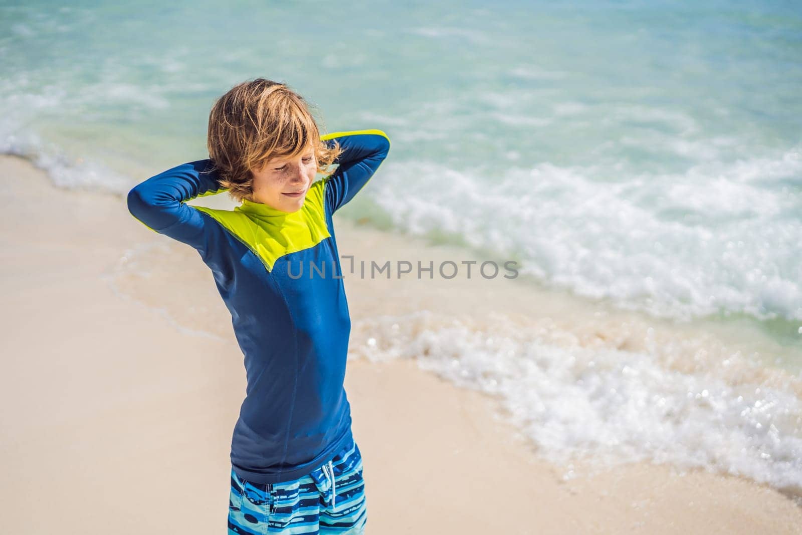 A carefree boy explores the wonders of the beach, with the sun-kissed shoreline as his playground, embodying the spirit of childhood adventure by galitskaya