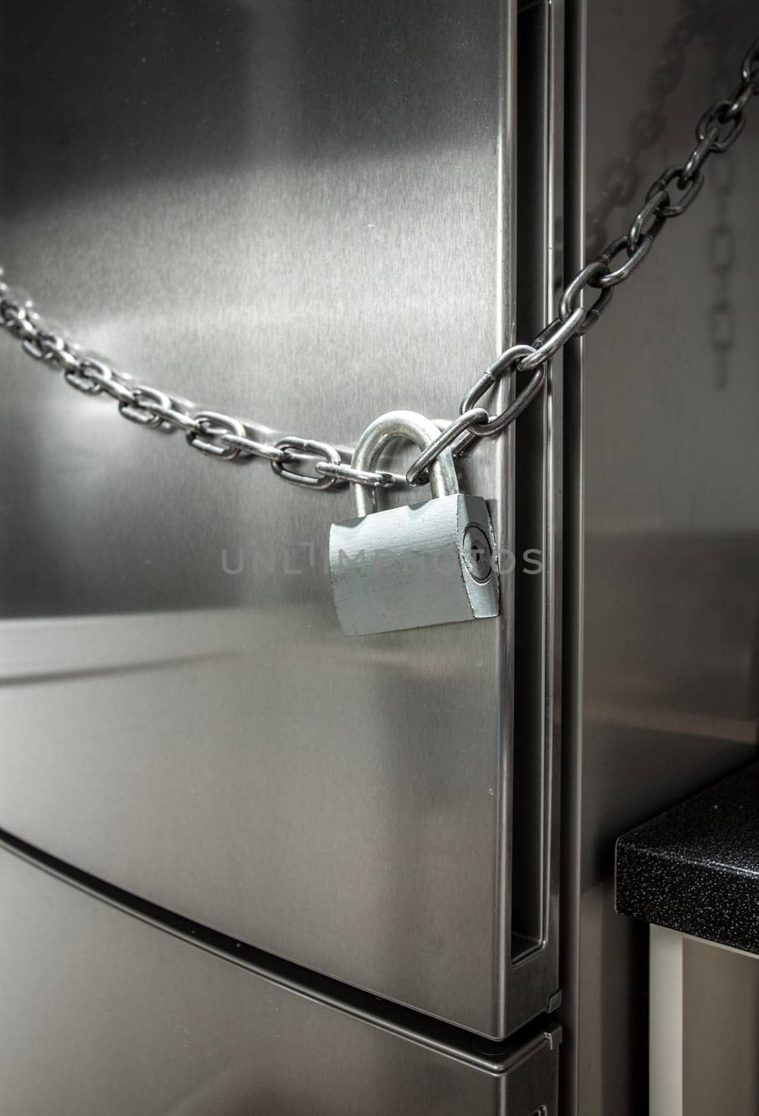 Closeup photo of metal chain on fridge