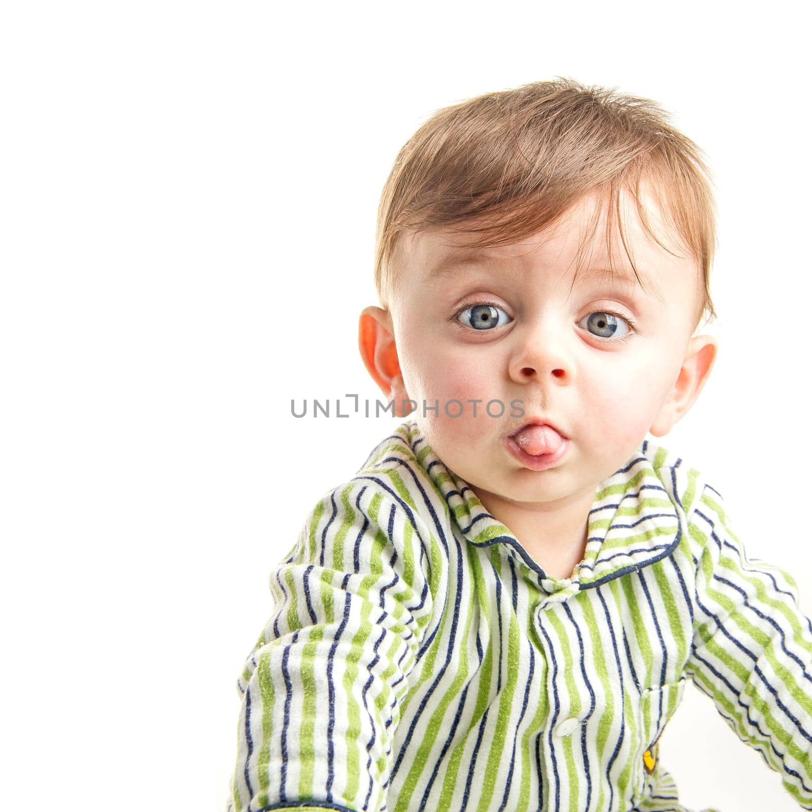 Baby grimacing to the camera on white background