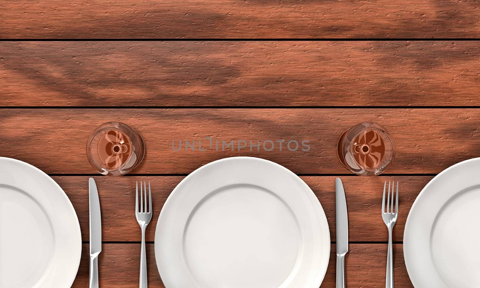 Knife, fork, glasses and white dishes on the dining table