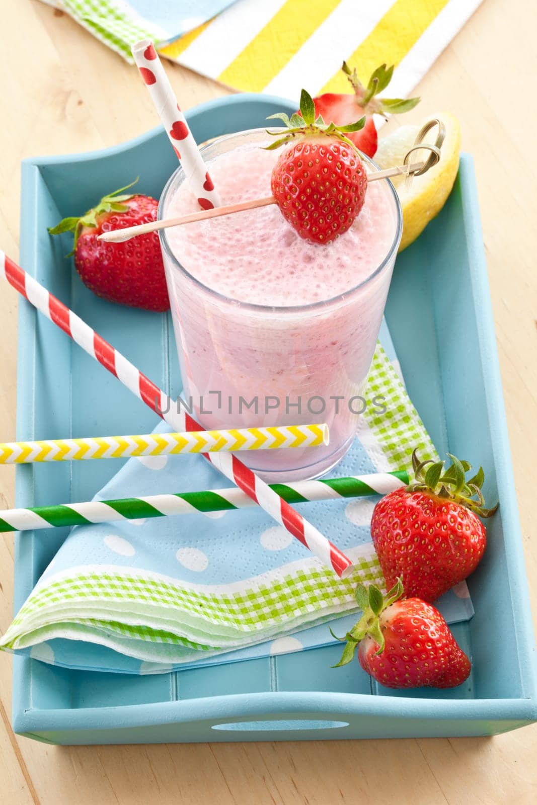Milkshake in glass with fresh strawberries