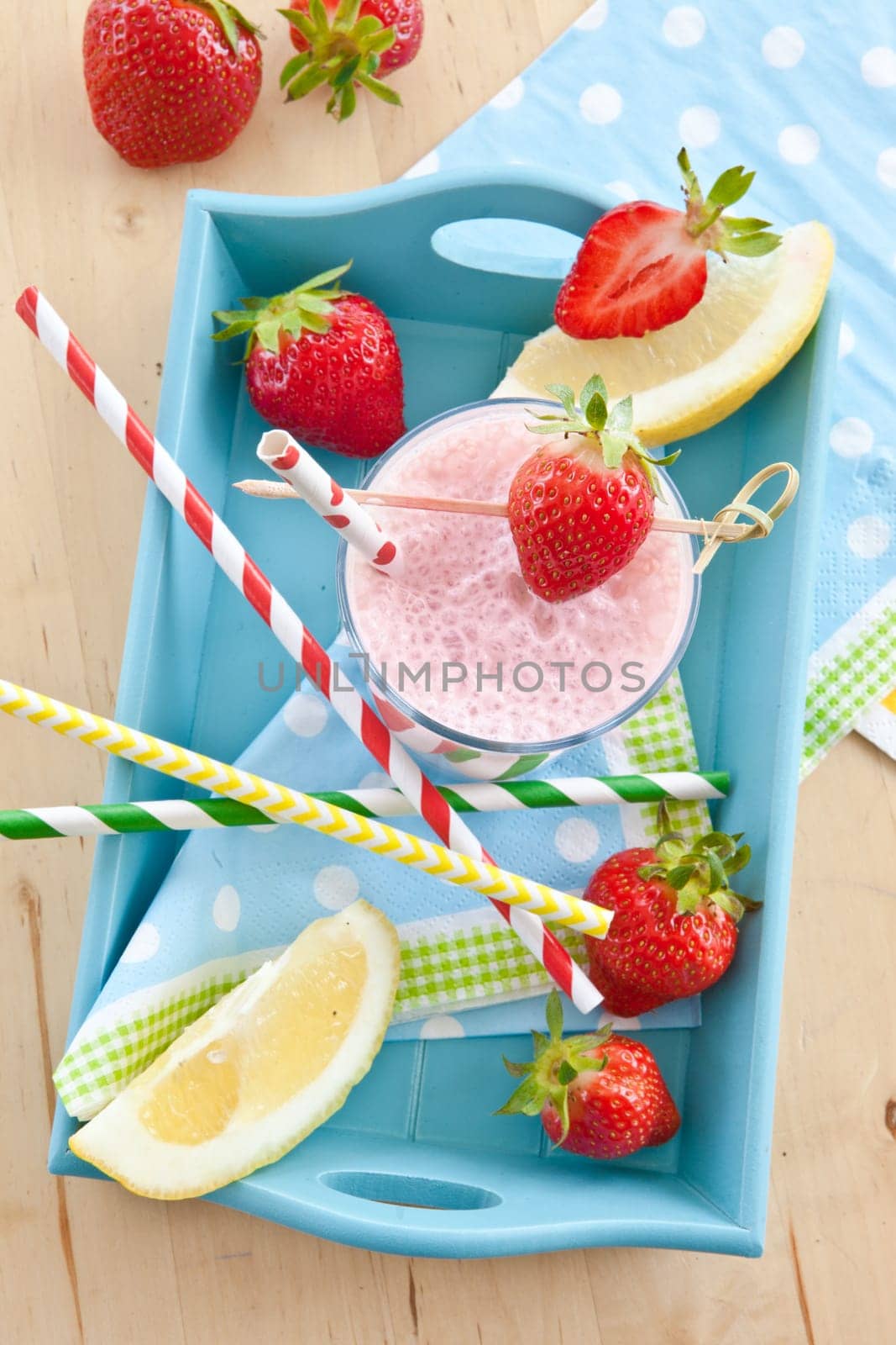 Milkshake in glass with fresh strawberries