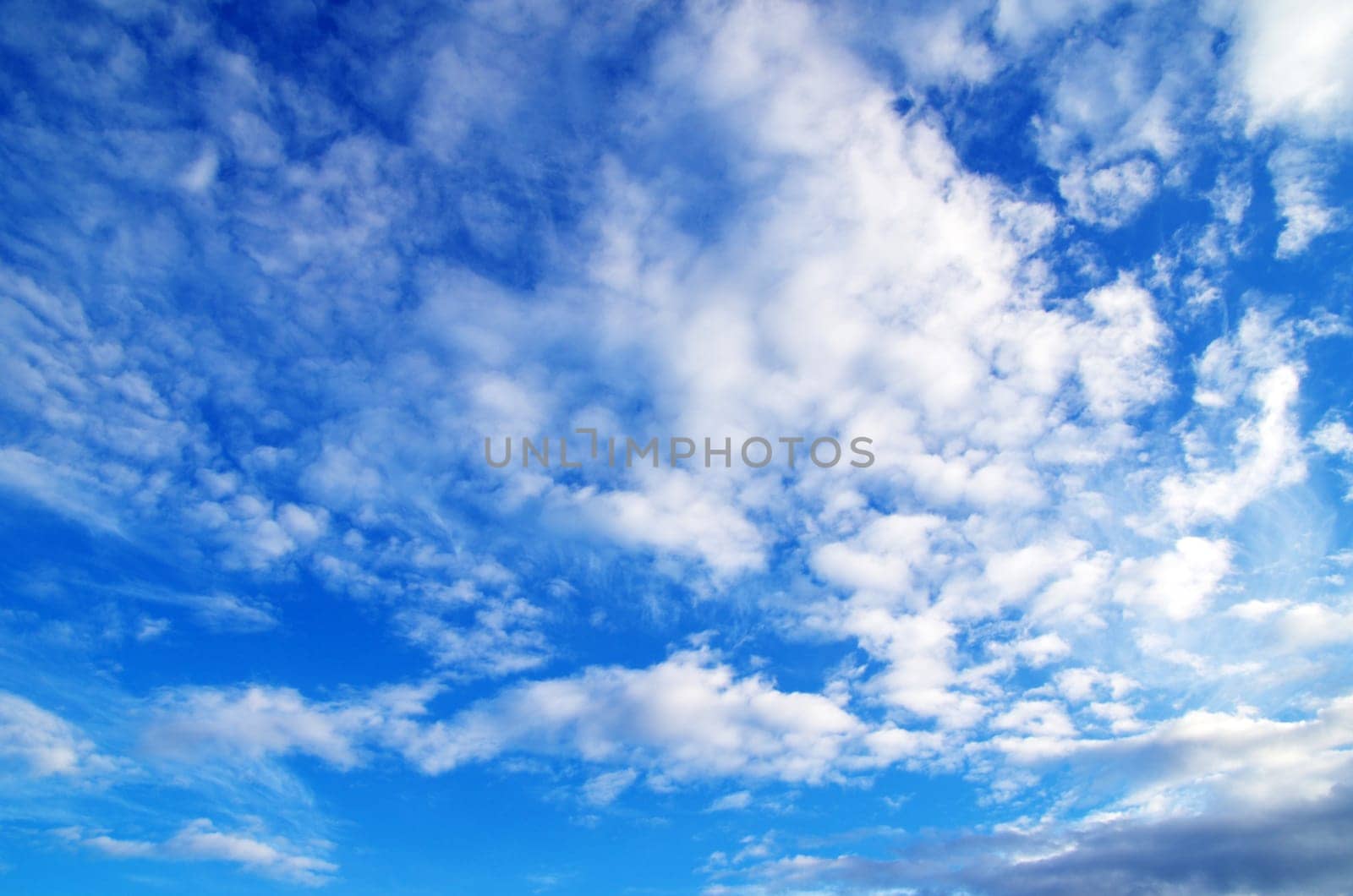 Blue sky background with tiny clouds