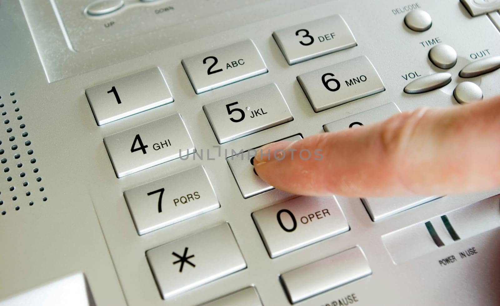 finger with grey telephone keypad