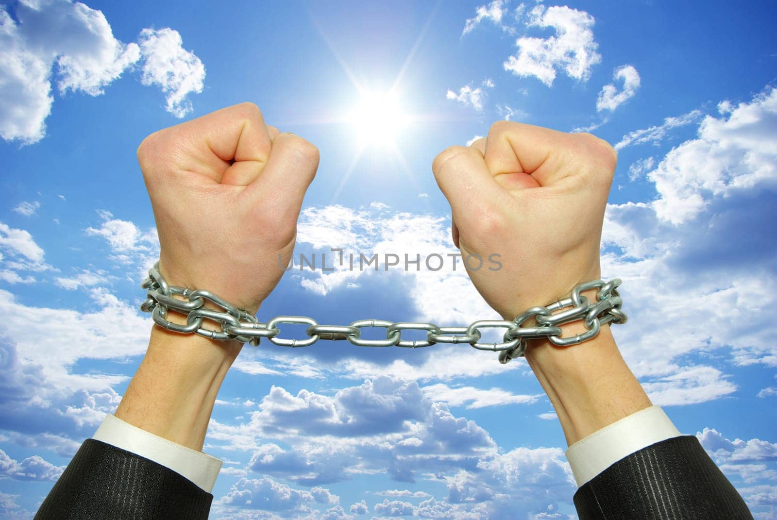 Hands in chains on a background sky