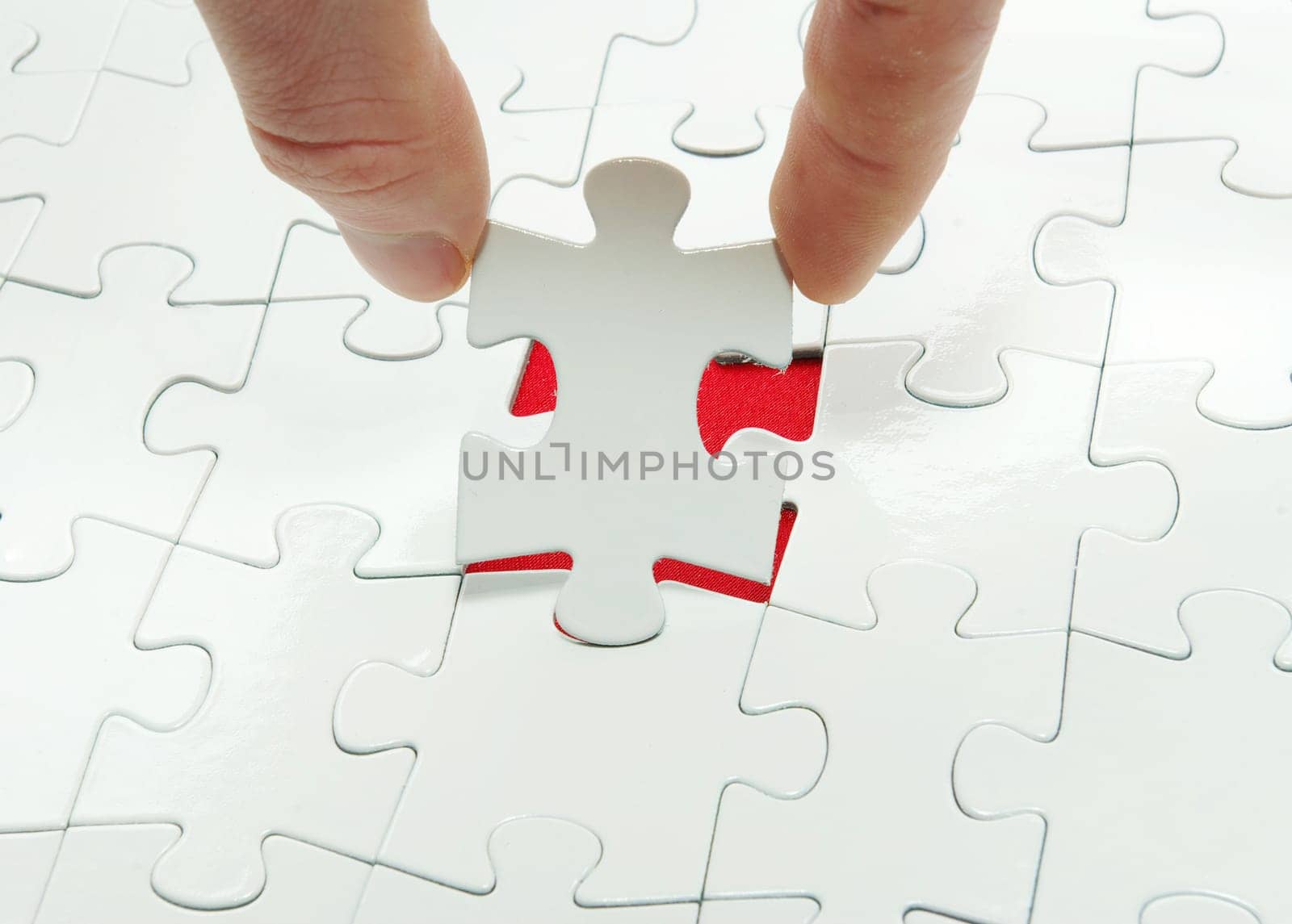 hands holding a puzzle piece . business concepts