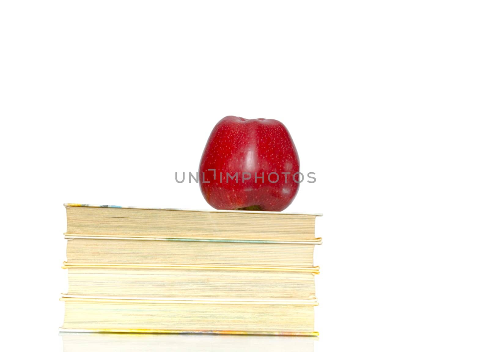 Red apple and stack of books for school