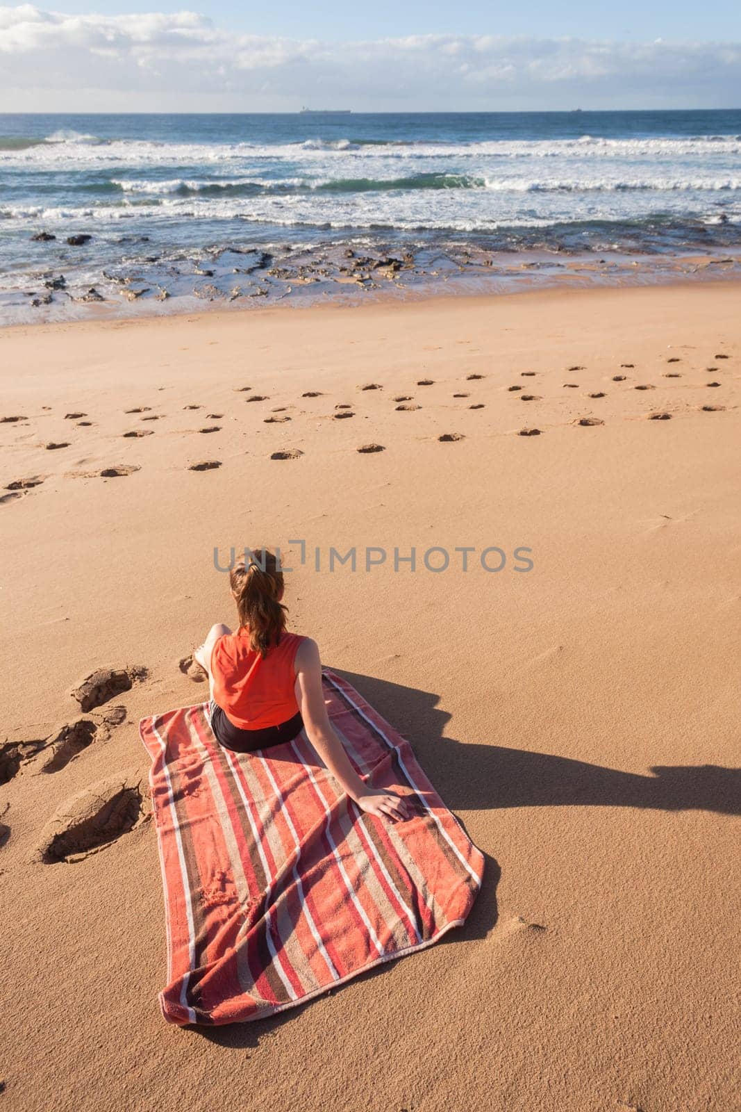 Girl teenager daughter exploring ocean beach sand rock reefs pools at low tide