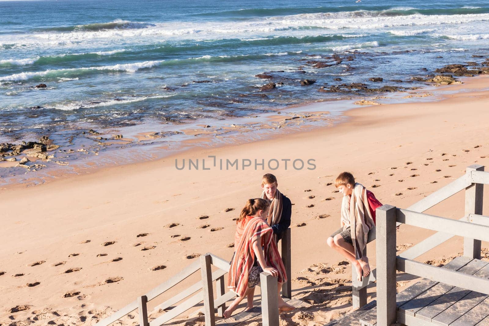 Girl teenager daughter exploring ocean beach sand rock reefs pools at low tide