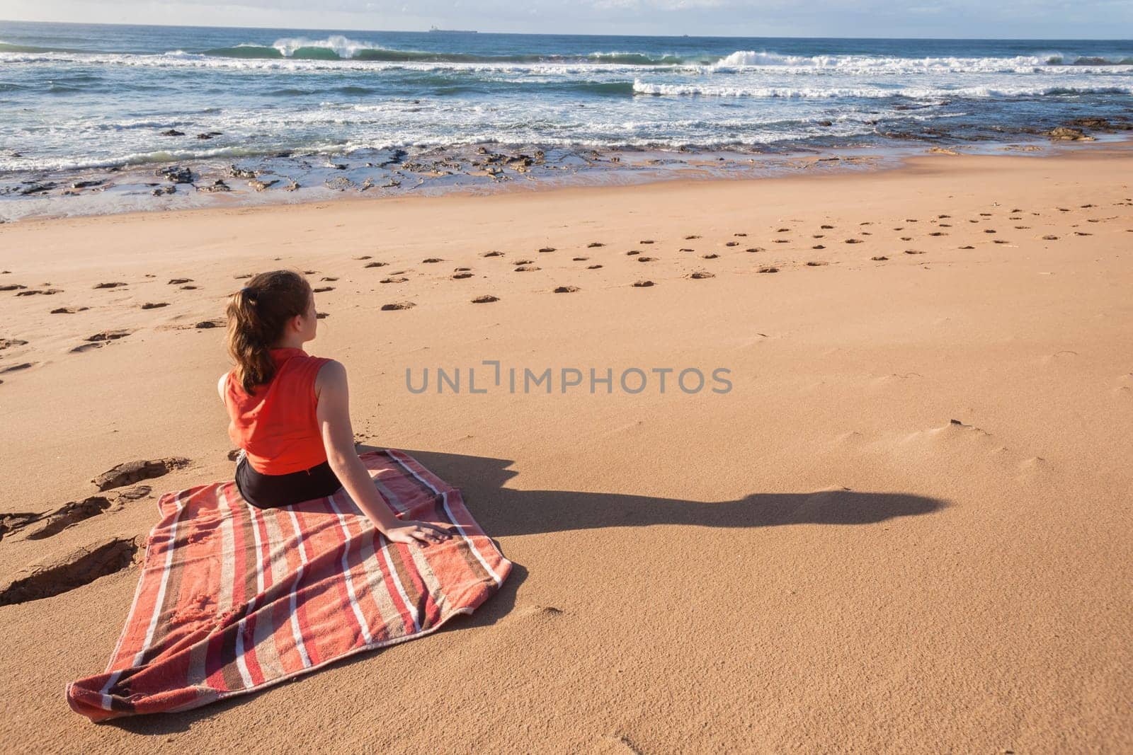 Girl teenager daughter exploring ocean beach sand rock reefs pools at low tide