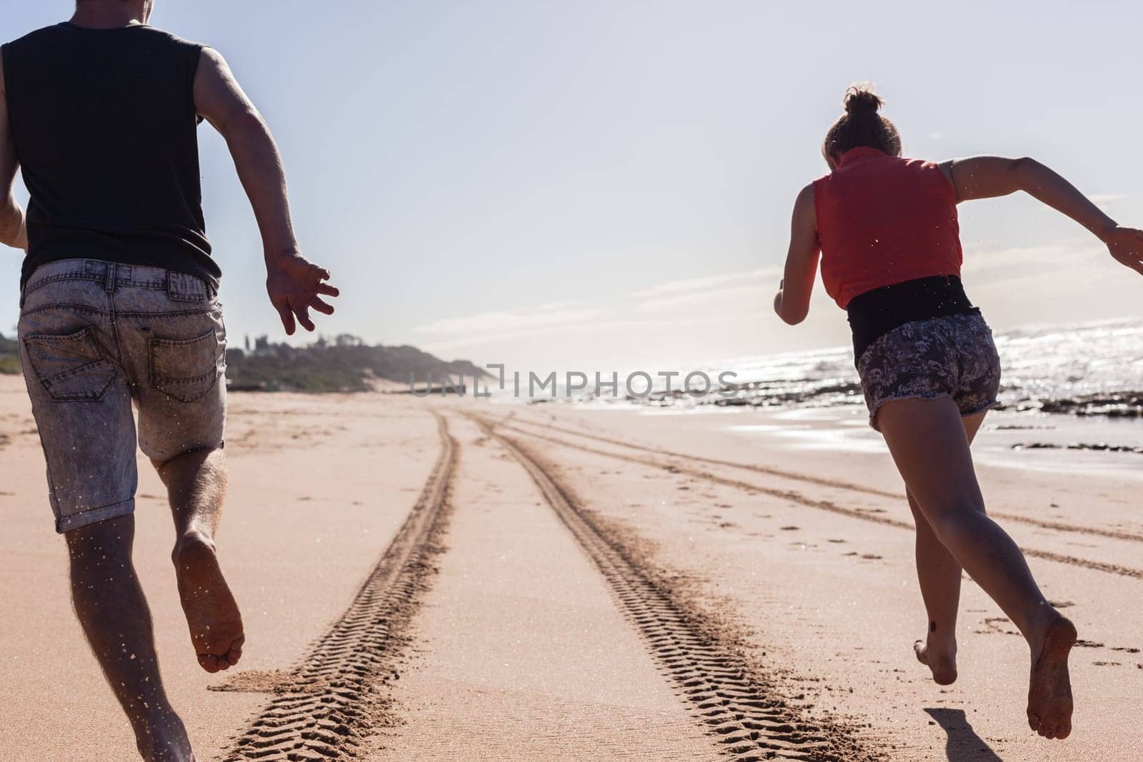 Girl teenager daughter exploring ocean beach sand rock reefs pools at low tide